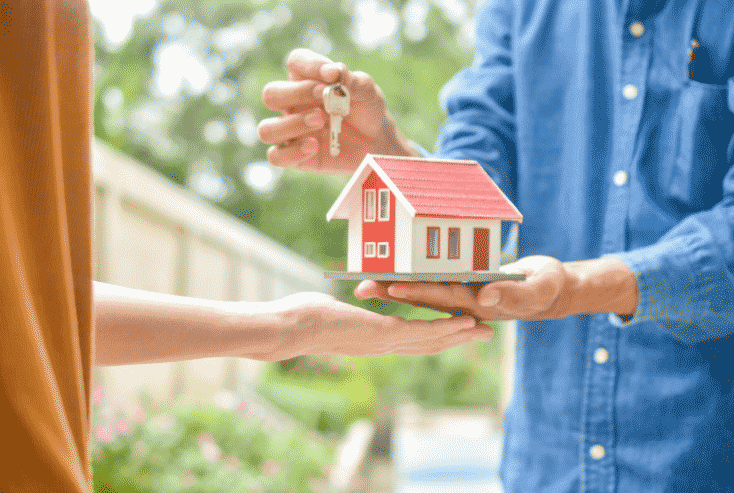 Buying - handing keys and model house